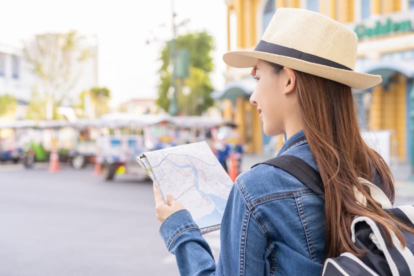 Traveler travel on vacation weekend, holiday in summer, smile asian young traveling woman, girl backpacker using map for sightseeing, keep walking along road, street outdoor market, city in Bangkok.